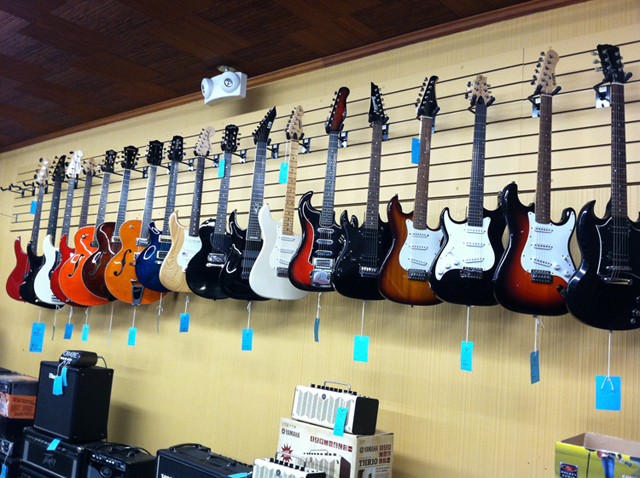 Electric guitars, acoustic guitars, banjos, guitar straps, guitar strings, and guitar cases at The Symphony Music Shop in North Dartmouth, MA